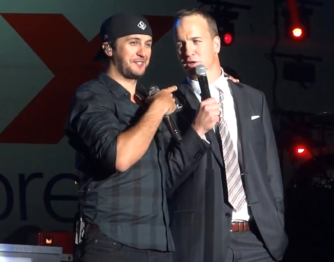 (L-R) Luke Bryan and Peyton Manning on stage