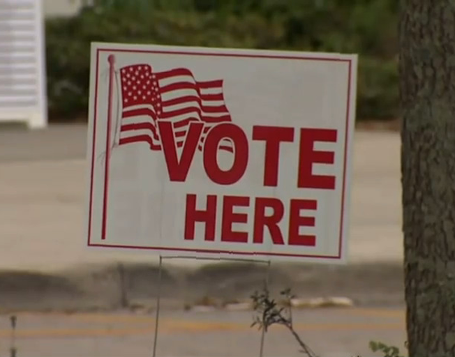 "VOTE HERE" sign