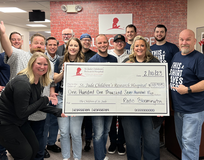 B104-Cumulus Radio Bloomington staff holding a check for St. Jude for $101,705.00