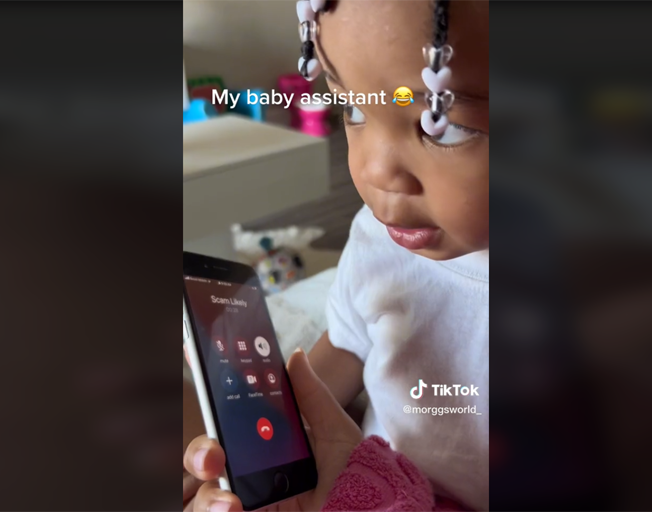 A toddler talking on the phone