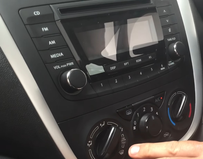 A car dashboard with buttons and knobs