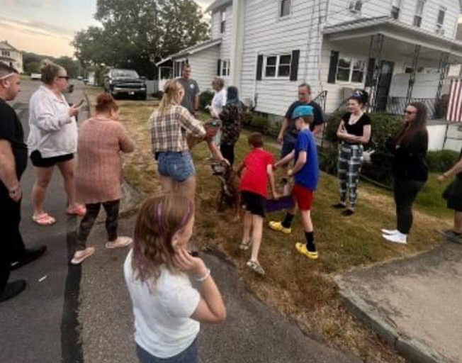 People saying goodbye to dog named "Mellow" on his last walk