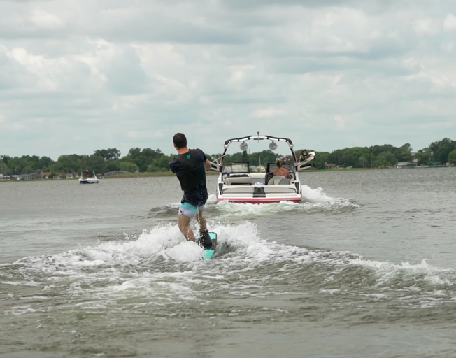 A man wakeboarding on a lake