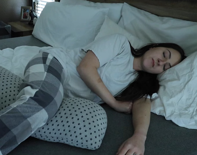 A woman asleep in a bed