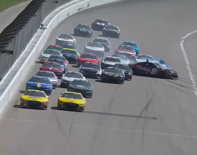 Kyle Busch sliding in the 8 car through a pack of cars racing at Kansas Speedway 05-07-23